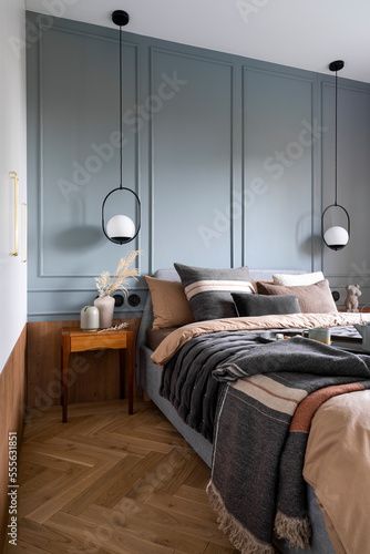 Stock Image: Interior design of cozy bedroom with brown and grey bedding, pillows, bedside table, vase with dried flowers, sculpture , hanging lamp and personal accessories. Home decor. Template. Smoky Blue Bedroom, Muted Blue Bedroom, Brown Grey Bedroom, Deep Blue Bedroom, Light Brown Bedrooms, Blue And Grey Bedroom, Vase With Dried Flowers, Flowers Sculpture, Modern Cabin Interior