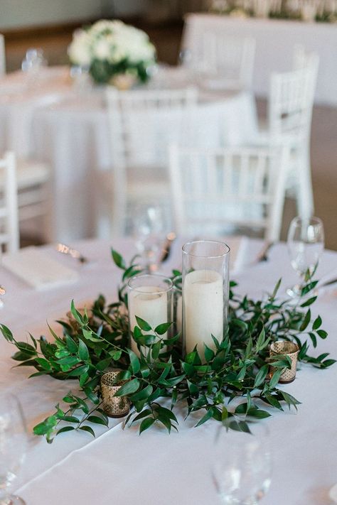 Wedding Greenery Head Table, Greenery Tablescape Round Table, Morning Wedding Reception Decoration, Greek Centerpieces Table Decorations, Wedding Greenery And Candles, Round Greenery Centerpiece, White And Greenery Wedding Centerpieces Round Table, Candle Table Arrangements, Round Table With Greenery