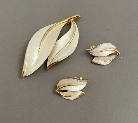 Brooch length 2 3/4 inches  Earrings            1 +     Inch  Bright and brushed gold tone metal with silver-tone-finish accents. Sleek and stylish vintage jewelry.  Signed on all 3 pieces: @SarahCov.  I do not know the age of this set although my estimate is late 1960s.  Good estate condition with light wear consistent with age and usage. Please view and enlarge the photos for condition assessment and to appreciate the features and design.  Thanks for visiting today. Questions welcome;  start a 1970s Jewelry, Flatware Patterns, Sarah Coventry Jewelry, Pin Earrings, Louisville Kentucky, Sarah Coventry, Vintage Costume Jewelry, Vintage Costumes, Gold Tone Metal