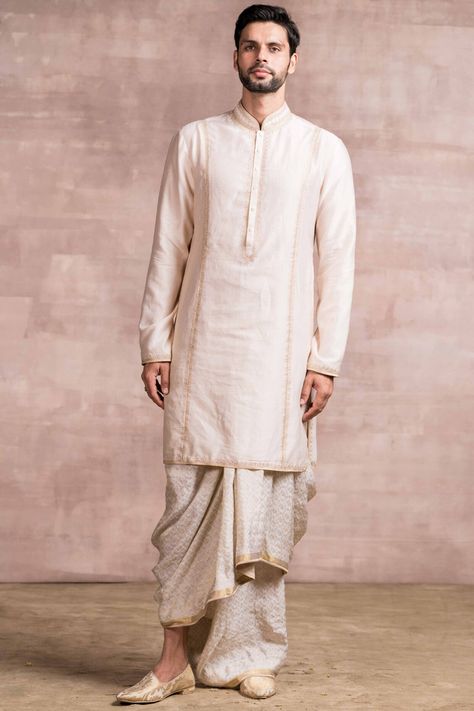 Featuring an ivory kurta in chanderi base with chikankari embroidery. It is paired with matching dhoti in silk jacquard base.  FIT: True to size. COMPOSITION: Chanderi, Silk jacquard. CARE: Dry clean only. Dhoti Pants For Men, Indian Wedding Clothes For Men, Mens Indian Wear, Wardrobe Planner, Wedding Kurta For Men, Groom Dress Men, Chikankari Embroidery, Chikankari Kurta, Red Kurta