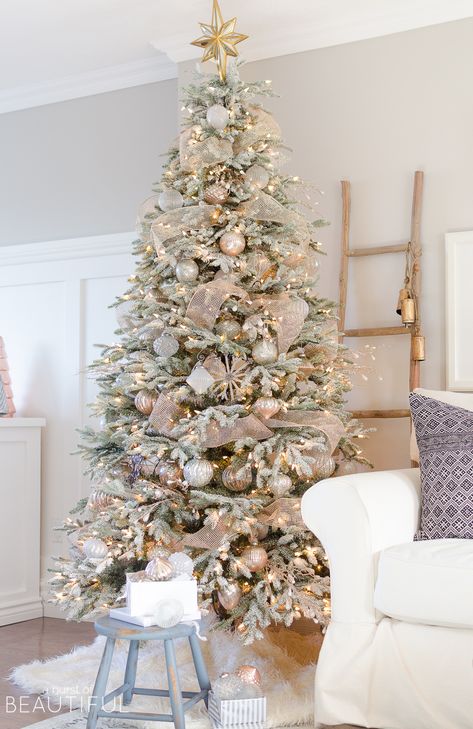 A snowy flocked Christmas tree decorated in silver and rose gold adds a big dose of holiday cheer to this modern farmhouse living room Rose Gold Christmas Decorations, Christmas Tree Decorated, Flocked Christmas Tree, Flocked Christmas Trees Decorated, Snowy Christmas Tree, Silver Christmas Decorations, Rose Gold Christmas, Farmhouse Christmas Tree, Gold Christmas Decorations