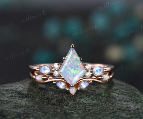 This ring is handmade by myself. The main stone is a 6x9mm kite cut Lab opal. The accent stones are round 1.5mm moissanites and marquise 2x4mm moonstones.. The wedding band stones are round lab opals and marquise moonstones. The material is solid gold(white,yellow,rose gold available) Ring size can be choose from the selection box. This jewelry can also be made in solid 10k,14k,18k gold,with real diamonds.Contact me! Need rush order? contact me! Need custom making order? Contact me! I have confidence on my jewelry.30 days money back guarantee!(For returned item,as this is handmade jewelry.Handcrafted fee and shipping fee will be deducted,others will be refunded soon) Thanks for your visiting! White Opal Engagement Ring, Opal Engagement Ring Rose Gold, Topaz Birthstone, Opal Engagement Ring, Engagement Ring Rose Gold, Opal Engagement, Engagement Rings Opal, Set Jewelry, Rose Engagement Ring