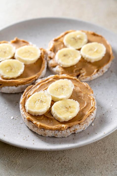 Rice cake with banana and peanut butter, healthy protein snack royalty free stock photo Peanut Butter On Rice Cakes, Rice Cakes With Peanut Butter And Banana, Rice Cake Peanut Butter Banana, Peanut Butter Banana Rice Cake, Banana Peanut Butter Snack, Peanut Butter Rice Cakes, Banana And Peanut Butter Snack, Almond Daughter Food, Rice Cake Peanut Butter