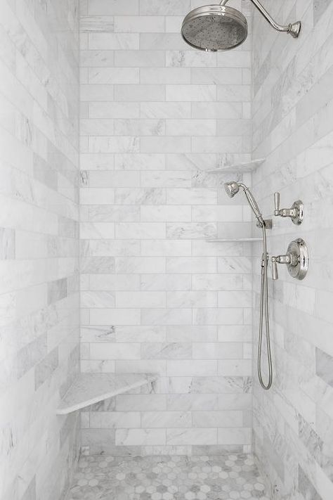 A vintage polished nickel rain shower head is mounted against honed marble subway shower surround tiles over honed marble hex floor tiles. White Marble Shower, Marble Shower Tile, Home Bunch, Marble Showers, Tiled Shower, Interior Minimalista, Bad Inspiration, Master Bath Remodel, Bathroom Shower Tile