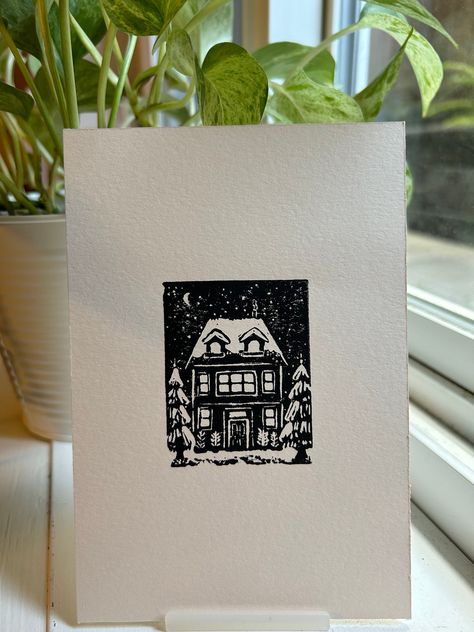 Home for Christmas, this is an original lino print. My favourite Christmas tradition is to watch the movie Home Alone 2: Lost in New York. I wanted to design a family house and imagine all the festivities throughout Christmas day; from picking out a tree, sitting down for dinner, or last minute-gift wrapping. I also wanted to experiment with the contrast of snow and loved how the trees turned out. Print Details - Hand-carved lino printed with Black ink on Fabriano: Print-making Paper (made in It Block Printing Christmas Cards, Winter Lino Print, Christmas Card Print, Christmas Linocut Prints, Block Print Christmas Card, Christmas Card Lino Print, Linocut Christmas Cards, Christmas Block Print, Lino Christmas Cards