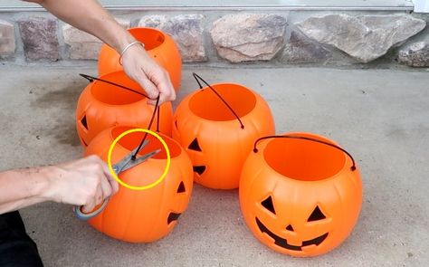 What says fall more than pumpkins? Here is a super easy and inexpensive way to dress up your porch for fall.    Step 1: Get pumpkins Run, do not walk, to Walmart where plastic pumpkin pails are only $1.00 while supplies last.For one planter, purchase 5 pumpkins.    Step 2: Rebar Purchase 4' rebar rods and place them into a pot (yellow circles). Secure with stones and soil.I made two planters so I purchased 2 rebar rods and 10 pumpkins.    Step 3: Cut the Handles We don't need the handl… Stackable Plastic Pumpkins, Stackable Pumpkins For Front Porch, Pumpkin Planter Diy, Outdoor Pumpkin Decor, Pumpkin Planters, Pumpkin Run, Candy Baskets, Halloween Mats, Shabby Chic Fall