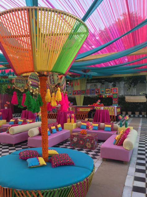 Haldi and Mehndi are the events where you can go quirky and unique with the decor. Carnival theme is all around colour and fun-filled ambience. Vibrant drapes, genda phool and some game stalls brighten up the whole decor done by Abhinav Bhagat Events at Radisson Blu Udaipur Palace Resort And Spa.#indianweddingdecor #weddingDecor #weddingdecorinspiration #decorinspiration #india #carnivalthemedecor #carnivaltheme #weddingdecorideas #decorideas #weddingideas #wedding #decorideasforwedding #mehndi Carnival Wedding Theme, Ambience Decor, Genda Phool, Wedding Carnival, Haldi Decoration Ideas, Stall Decorations, Mehndi Function, Mehendi Decor Ideas, Mehendi Decor