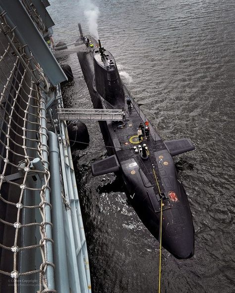 Royal Navy Astute class submarine HMS Ambush is pictured alongside the forward support vessel RFA Diligence in Gareloch, HMNB Clyde, Scotland. Royal Navy Submarine, Navy Aviation, Navy Submarine, Royal Navy Ships, Rubber Raincoats, Nuclear Submarine, Naval Force, Mil Spec, Work Gear