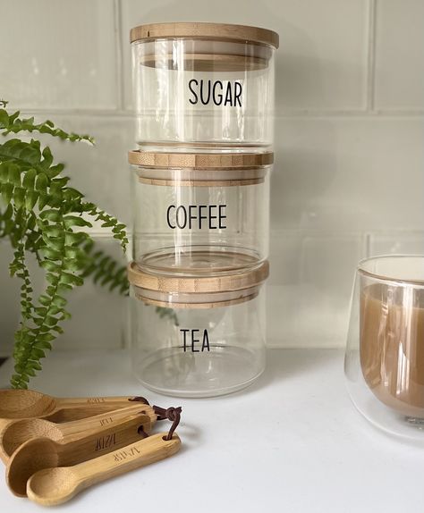 Crafted from glass and bamboo to create three stacking jars, labelled coffee, tea and sugar. Complete with air tight lids to keep food items fresh. Can be placed side by side too. perfect for small spaces in your kitchen and creating a stylish contemporary look.  MATERIALS; Borosilicate glass x3                          Bamboo lids x3  DISHWASHER SAFE;   NO MICROWAVE SAFE;     NO Wash with soapy water             Dimensions  W 10.10 x L 10.10 x H 23.10cm.                         You can also find us on Adorehomeware.co.uk