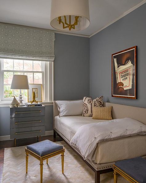 Blue lacquer nightstand against a bedroom window fitted with a Roman shade beside a twin corner bed dressed with tan bedding and a frame with nailhead trim. Wall Lights Beside Bed, Lights Beside Bed, Bedroom Wall Lights Beside Bed, Corner Twin Bed, Blue Guest Bedroom, Bed Against Window, Corner Twin Beds, Bed Against Wall, Liz Caan