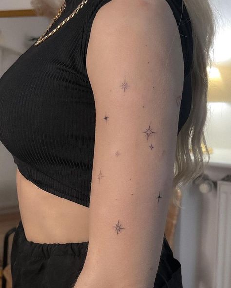 Upper Arm Line Tattoo, Star Tattoos On Shoulder Woman, Small Tattoo Cluster, Arm Stars Tattoo, Stars Around Tattoo, Made Of Stars Tattoo, Upper Arm Star Tattoo, Arm Star Tattoos For Women, Sparkle Tattoo Sleeve