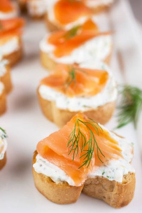 This Smoked Salmon Crostini recipe is an easy and flavorful appetizer! The crostini is toasted in the oven until crispy and then rubbed with garlic. It's topped with a creamy ricotta cheese mixture made with lemon juice, lemon zest, and fresh dill. The ricotta spread is added to the bread and topped with slices of smoked salmon. This Italian inspired appetizer is gluten free. It's perfect to serve at parties any time of the year! This dish is full of flavor and fun to eat. Smoked Salmon Crostini, Garlic Baguette, Salmon Crostini, Ricotta Spread, Gluten Free Party Food, Ricotta Crostini, Smoked Salmon Appetizer, Crostini Recipe, Salmon Appetizer