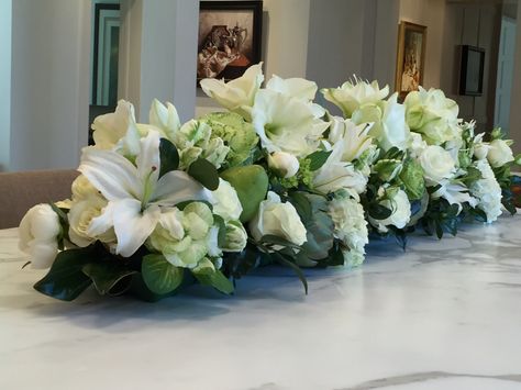 White and green long and low centerpiece with kale, parrot tulips, amaryllis, roses, peonies, magnolia, lilies, hydrangeas, pears and artichokes. Flower Centerpieces Long Table, Long And Low Centerpiece, Natural Centerpieces, Peonies Centerpiece, White Floral Arrangements, Low Centerpieces, Spring Floral Arrangements, Parrot Tulips, Wedding Floral Centerpieces