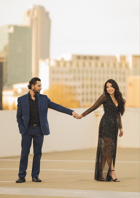 Magic hour, city backdrop engagement photoshoot. Black and blue suit, black sequin dress. Couple engagement poses. Black Dress Blue Suit Couple, Black And Blue Suit, Backdrop Engagement, City Backdrop, Dress Couple, Magic Hour, Engagement Poses, Navy Suit, Suit Black