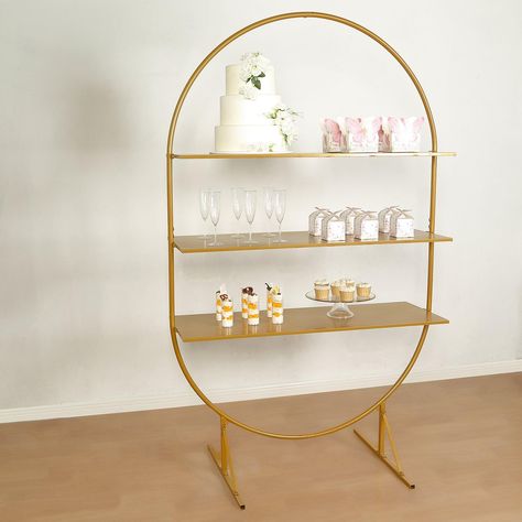 PRICES MAY VARY. Quantity: 1 Dessert Display Stand + Bag of Tools Material: Metal Color: Gold Style: 3-Tier Oval Arch Shelf Rack Overall Size: 3.87ft L x 1.97ft W x 6.5ft H Base Size: 30"L x 23.5"W Panel Sizes: 45"L x 16"W (Total 3 Panels) Spaces Between Panels: 12" Round Pole Thickness: 22mm Base Square Pole Thickness: 20mm Weight Capacity: 70lbs Assembly Required: Yes. Easy To Assemble. Instructions Included: Yes Features: Sturdy, Multipurpose, Durable & Reusable Elegant Display: Elevate your Wedding Cupcake Table, Arch Cake, Wedding Cupcake Display, Cupcake Table, Cupcake Display Stand, Dessert Holder, Dessert Display Stand, Cupcake Stand Wedding, Gold Cupcakes