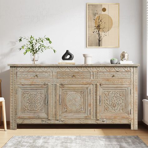 In the fusion of natural wood grains, distressed finish, hand carving details, and meticulously chosen other hues, Our Mendocino Distressed Hand Carved Mid Century Sideboard with 3 Drawers has a captivating and distinct aesthetic emerges. That is the magic of this mid-century sideboard – a showstopper that effortlessly combines nature’s allure with a touch of artistry, making it a true standout in any space. This multifunctional intricated hand-carved sideboard is a storage powerhouse with a sleek generous countertop surface, three cleverly dual-tiered cabinets, and three inline petite drawers. It is like a secret agent for your dishes and linens, complete with sturdy intricately hand-carved doors sporting sleek metal hardware equipped with wooden latches and drawers donning iron knobs for Carved Sideboard, Living And Kitchen, Painted Sideboard, Buffets & Sideboards, Countertop Surfaces, Mid Century Sideboard, Antique Sideboard, Solid Wood Sideboard, Wooden Sideboard