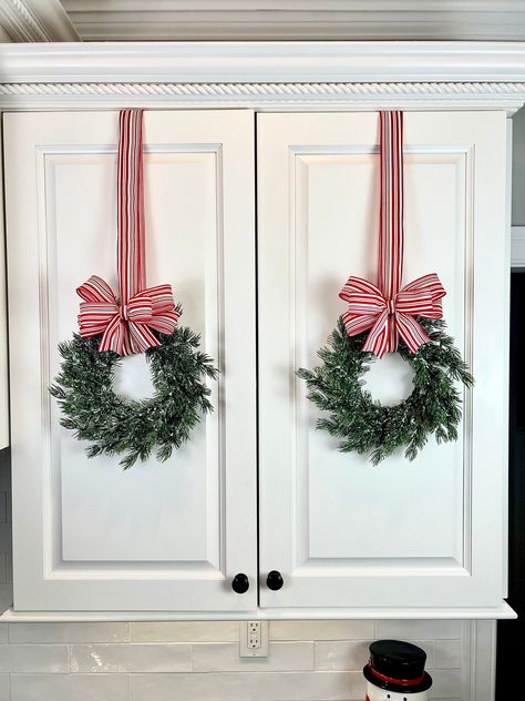 Mini Christmas cabinet wreath, evergreen wreath, small wreath, farmhouse Christmas decoration, holiday wreath,set of mini wreaths, pine wreath Beautiful mini holiday wreaths that can be used in so many ways.  They look great on cabinet doors and offer a special touch to your holiday decorating. Use them on all of your cabinet doors or just highlight a few---the possibilities are endless.  Each wreath is artificial evergreen dusted with flocked snow. With each wreath you will receive 1 yard of ribbon and a handmade bow that you can easily adjust to the length of your choice.  These wreaths are sturdy and will be able to be used for many years to come. Sold in sets of 2 wreaths-- if you have a different number needed please message us!  * We have many more ribbon choices please be sure to re Small Front Door Christmas Decor Ideas, Small Window Wreaths Christmas, Christmas Wreath On Cabinet Door, Small Wreaths On Kitchen Cabinets, Kitchen Hood Christmas Decor, Bathroom Decorated For Christmas, Christmas Cabinet Wreaths, Christmas Wreaths Outside Windows, Christmas Bow Wreath