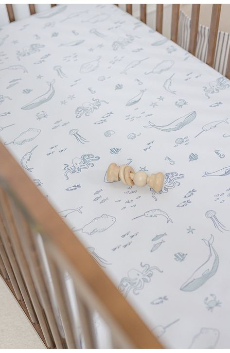 Perfect for a neutral nursery, this darling crib sheet patterned in sweet bunnies is woven from supersoft brushed organic cotton to keep baby comfy. 100% organic cotton Machine wash, tumble dry Imported Kids' Wear Nautical Decor Nursery, Coastal Boys Nursery, Sage Green And Blue Nursery, Beach Boy Nursery, Ocean Themed Nursery Boy, Under The Sea Nursery Boy, Coastal Nursery Neutral, Sea Nursery Boy, Ocean Nursery Baby Boy