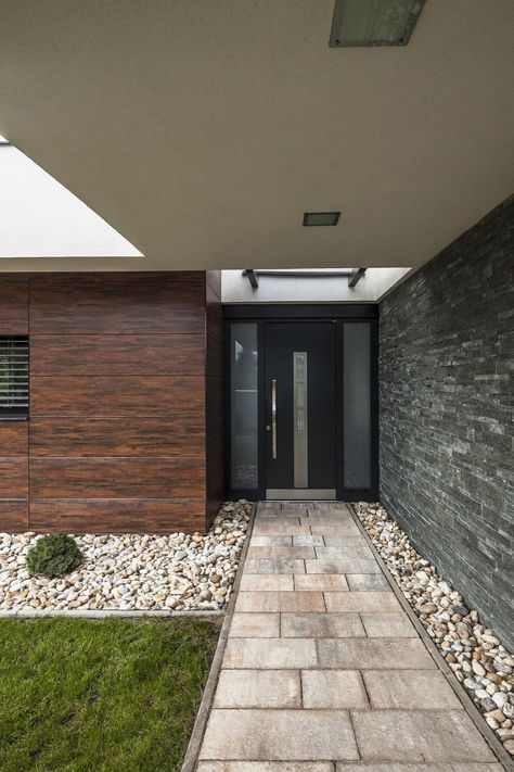 This private residence is located in Mosonmagyaróvár, a town in Győr-Moson-Sopron county in northwestern Hungary. It was designed by TOTH PROJECT and was built as a home for a four-person family. Home in Mosonmagyaróvár by TOTH PROJECT: “The building can be found in a quiet, suburban residential park of Mosonmagyaróvár of north-western Hungary. It is a one-family house for a four-person family. Fortunately our relationship with the clients began in.. Pond House, Modern Front Door, Modern Garage, Concrete Roof, Garden Pond, Front Door Design, Roof Top, Modern Exterior, House Entrance