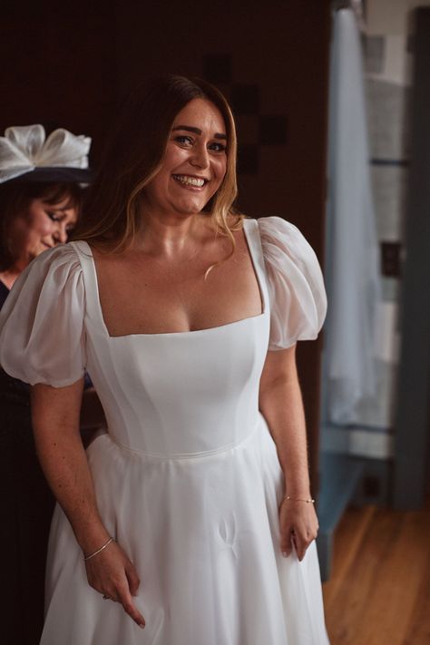 Smiling happy bride in a puff sleeve Suzanne Neville wedding dress. Bridgerton inspired bride. The Springles Photography. Morning Wedding Dress, Bridgerton Style Wedding, Cowley Manor, Suzanne Neville Wedding Dress, Glamorous Curls, Tiered Wedding Dress, Bridgerton Style, Colourful Bouquet, Puff Sleeve Wedding Dress