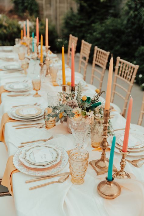 There are so many good things about this playful head tablescape, we are hardly know where to begin! From the layered linens where the vibrant teal peaks through, to the multicolored candles in our vintage brass candlesticks, to the hand-lettered and dip-dyed place cards - there are so many good details that work together to create this striking tablescape. #Chattanooga #wedding #colorfulwedding #weddingdecor #tablescape Brass Candlesticks Tablescape, Wedding Brass Candlesticks, Taper Candle Centerpiece, Candle Tablescapes, Candlestick Centerpiece Wedding, Boho Reception, Taper Candles Wedding, Backyard Boho, Colored Taper Candles