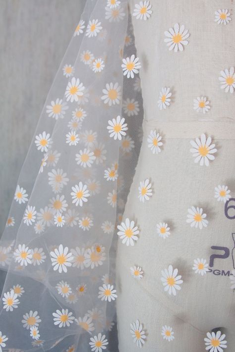 "Arriving next week. Back in stock by demand. Orders yours before it's gone. Need a cute, lightweight & sheer fabric for your special occasion? This printed daisies on off white tulle is perfect for the bride to be, flower girl or even just as window shades! Make hair ties and head bands with this daisy flower tulle. It is 63\" wide so 1 yard would be plenty for hair accessories. How about some pretty socks to go with your wedding guest attire? Use your creativity and I'm sure you'll find a spec Daisy Flower Painting On Fabric, Textile Flower Design, Saree Hand Painting Designs, Floral Fabric Prints, Fabric Painting Ideas, Dupatta Painting, Flower Tulle, Pretty Socks, Saree Painting Designs