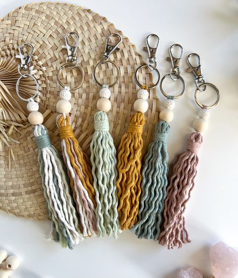 Brighten up your key ring, backpack or purse with a fringe tassel keychain! Every one is handmade with a white lava bead, wooden bead, cotton rope & a metal clasp. For my essential oil lovers out there, you can add a drop or two to the lava bead so your favorite blends will follow you throughout the day! Dimensions Bead + tassel length: 5.5" Full length: 7.5" Turnaround time + shipping Each keychain is handmade to order! Please allow for 3-5 business days before it ships off to you. Custom Reque Crafts With Metal Rings, Diy Boho Keychain Ideas, Crochet Beaded Keychain, Macrame Tassel Diy, Wooden Beads Crafts, Tassels Ideas, Diy Tassel Keychain, Macrame Keyrings, Boho Tassel Keychain