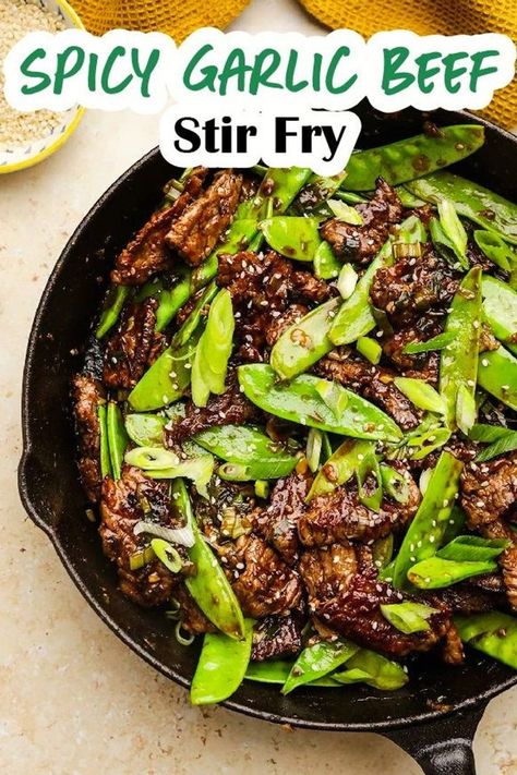 Spicy Garlic Beef Stir Fry is a great busy weeknight dinner! Flank steak, onions, and snow peas in a stir fry sauce full of garlicky, spicy, and sweet flavor. Easy Mongolian Beef is a quick beef stir fry dinner that readers love to make when they want Asian Food fast. Beef And Pea Pods Stir Fry, Beef And Snow Pea Stir Fry, Garlic Beef Stir Fry, Thai Beef Stir Fry, Spicy Beef Stir Fry, Stir Fry Dinner, Steak And Green Beans, Steak Stirfry Recipes, Stir Fry Meat