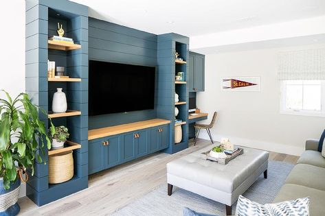 A flat panel television is mounted to a blue shiplap wall between wood floating shelves and over a wood countertop accenting blue shaker cabinets adorned with leather tab pulls. Tv Built In, Built In Entertainment Center, Living Room Built Ins, Coastal Contemporary, Living Room Entertainment, Rack Tv, Transitional Living, Tv Wall Unit, Transitional House