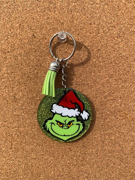 GRINCH KEYCHAIN! The keychain is a green, glittered acrylic keychain that is 2 inches in size. It represents the iconic Christmas character ... Mr. Grinch! Handle & Care info: - Acrylic can break if dropped or hit on hard surfaces - Avoid excessive temperature - Wipe with soft cloth to clean item NO REFUNDS OR EXCHANGES Grinch Keychain, Christmas Craft Fair Ideas To Sell, Preppy Grinch, Craft Fair Ideas To Sell, Grinch Ideas, Diy Grinch, Christmas Keychains, Grinch Crafts, Iconic Christmas