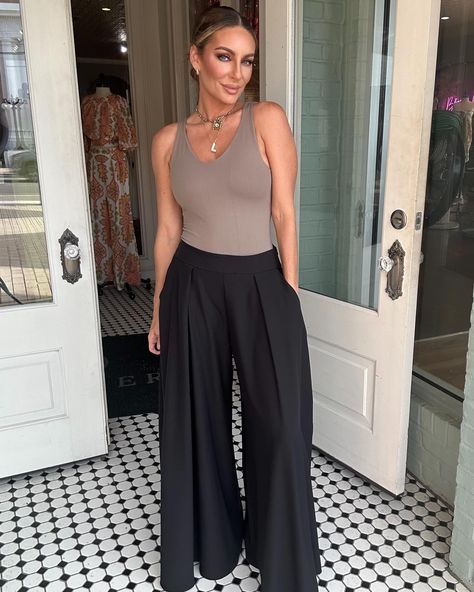 Made for comfort and style, these Ashley Wide Leg Pants provide a flattering fit and give you the freedom to move (and groove) all day long. #womensclothingboutique #widelegpants #dresspants #comfortstyle #boutiqueclothing Flowy Work Pants, Black Satin Wide Leg Pants Outfit, Wide Legged Black Pants Outfit, Black Wide Leg Pants Outfit Summer, Wide Leg Black Trousers Outfit, Flowy Pants Outfit Dressy, Black Bottoms Outfit, Black Flowy Pants Outfit, Black Wide Leg Pants Outfit Casual