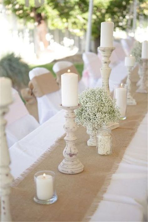 burlap runner over a simple white table cloths and rustic candle holder centerpieces Burlap Wedding Table, Centerpieces Rustic, Rustic Burlap Wedding, حفل توديع العزوبية, Burlap Runners, Tafel Decor, Candleholder Centerpieces, Rustic Candle Holders, Burlap Table Runners