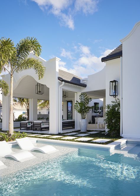 Three modern white pool loungers line a Baja pool ledge. Modern Florida Beach House, Coastal Modern Architecture, Beach House Design Exterior Coastal Homes, Florida Mediterranean House, Coastal Modern Beach House, Palm Beach Exterior Home, Mediterranean Coastal Style, Modern Coastal Backyard, Florida Spanish Style Homes