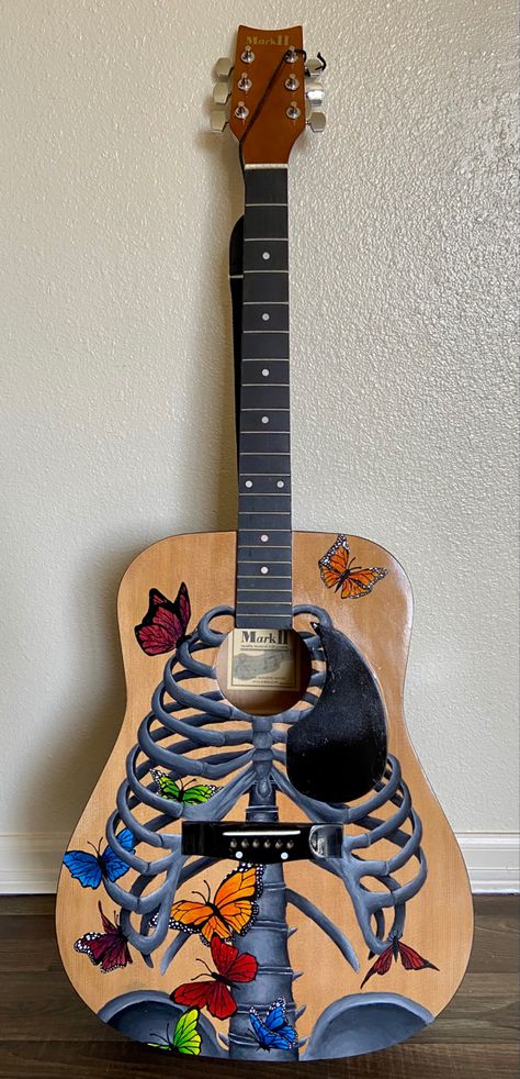 This guitar represents how nervous you are before stepping into the void. Butterflies flutter from your stomach to your heart. It was painted using acrylic, and finished September 2021. Painted Guitars Ideas, Painting On Guitar Ideas, Painted Guitar Acoustic, Guitar Painting Ideas, Painted Acoustic Guitar, Paint Guitar, Kdrama List, Painted Guitar, Into The Void