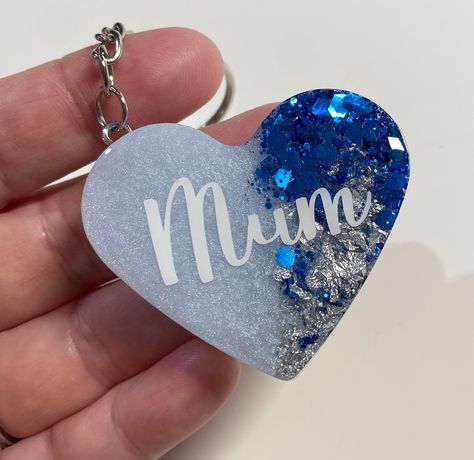 Personalised Blue Heart Keyring | Resin Keyring | Blue Keychain | Resin Glitter Keyring | Blue Gift | Birthday Gift | Accessories  Product  This beautiful blue mixed heart keyring is the perfect little accessory for any set of keys or handbag.  Personalised to let someone know you love them.  Options -  Mum  Mummy Gran  Granny Nana  Sister  Auntie  Bestie  Wifey  Name - send the name over in personalisation option.  Important  The Keyrings are all handmade to order, depending on stock, these do Resin Keyring, Name Keyrings, Keychain Resin, Blue Keychain, Vinyl Personalized, Resin Glitter, Heart Keyring, Diy Resin Crafts, Blue Gift