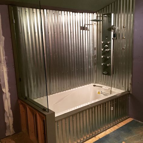 Drop in tub with corrugated metal surround and glass wall Galvanized Shower Walls, Metal Shower Walls, Tin Shower Walls, Galvanized Shower, Tiny House Build, Rustic Bathroom Shower, Bathtub Surround, Cabin Bathroom, Bathroom Shower Walls