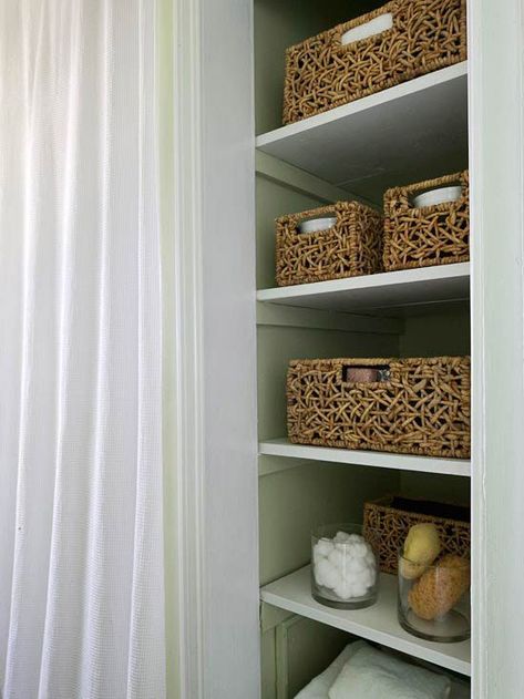 Removing bulky linen closet doors helped opens up a small area and keeps items accessible. Corralling like items ? wash cloths, cosmetics, etc. -- in baskets prevents the open storage from looking cluttered. Ideas Armario, Bathroom Closet Organization, Linen Closets, Open Bathroom, Bathroom Remodels, Bathroom Closet, Closet Door, Small Bath, Apartment Bathroom