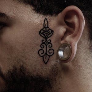 Face Tattoo By Ear, Side Face Tattoo, Small Face Tattoos, Vertical Tattoo, Alchemy Tattoo, Face Tats, Face Tattoos For Women, Maori Tattoos, Petit Tattoo