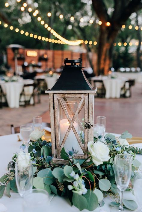 Lantern And Eucalyptus Centerpiece, Ivy And Candle Centerpieces, Wedding Table Centerpieces Sage Green, Eucalyptus Wedding Circle Table, Wood And Eucalyptus Wedding, Round Table Centerpieces Wedding With Lantern, Greenery Centerpiece Wedding Round Table, Lantern Centre Pieces, Lantern With Greenery Centerpiece