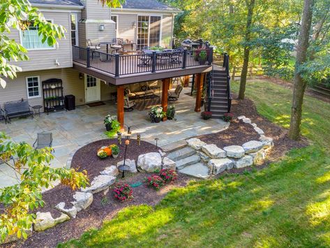 Patio Under Deck With Fire Pit, Backyard With Deck And Patio, Patio Below Deck Ideas, Space Under Deck Ideas, Patio On A Sloped Yard, Under Deck Garden Ideas, Back Deck Patio Ideas, Patio Under Deck Walkout Basement, Elevated Patio Ideas