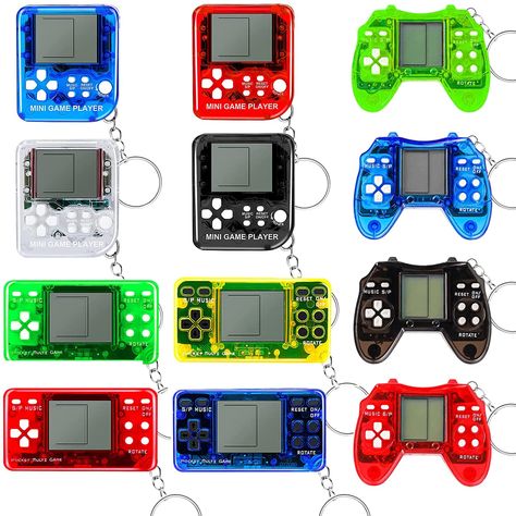 PRICES MAY VARY. 【12 PCS Mini Gamepads】You will receive 12 mini video gamepads of 3 styles in 4 different colors, including black, red, blue, green, yellow and transparent. With vibrant color and mini size, you can hang them on fingers, bags, or the party banner. Great to share with your brother, sisters and friends. 【Safe & Durable Material】Made of high quality plastic material with smooth edges, our video game keychain is lightweight to carry and sturdy to use. 【Built-in 26 Classic Games】Each Gaming Party Favors, Gaming Birthday Party Ideas Boys, Gamer Party Ideas Boys, Gamer Birthday Party Ideas, Video Game Theme Birthday Party, Video Game Party Ideas, Nintendo Switch Party, Gamer Party Favors, Gamers Party Ideas