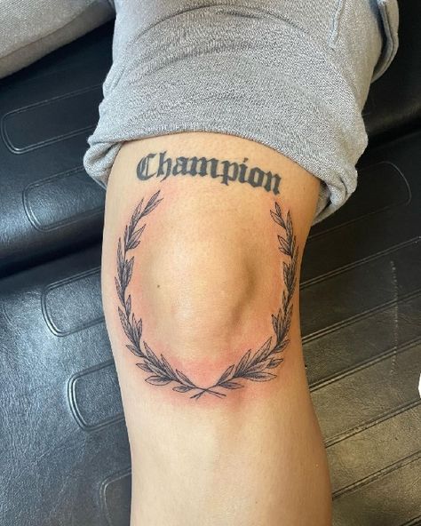 Champion Tattoo Ideas, Wreath Around Knee Tattoo, Olive Branch Tattoo Mens Knee, Knee Injury Tattoo, Vine Kneecap Tattoo, Around The Knee Tattoo Men, Olive Branch Knee Tattoo, Olive Wreath Tattoo, Men Knee Tattoo