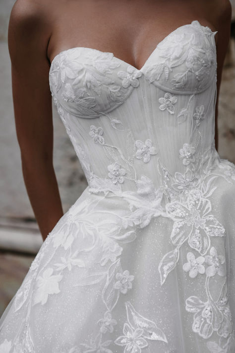 Experience timeless elegance in this strapless floral lace wedding gown. The intricate lace detailing adds a touch of romance, while the fitted bodice accentuates your figure beautifully. Perfect for brides looking for a classic yet sophisticated look on their special day. #weddingdress #florallace #straplessgown #bridalfashion #romanticbride #classicbride #weddinginspiration #elegantbride Small Wedding Dress Ideas, Girly Wedding Dress, Wedding Dresses Lace Corset, Modern Lace Wedding Dress, Bridal Era, Wedding Dress With Corset, Strapless Wedding Dresses, Basque Waist, Pretty Wedding Dresses