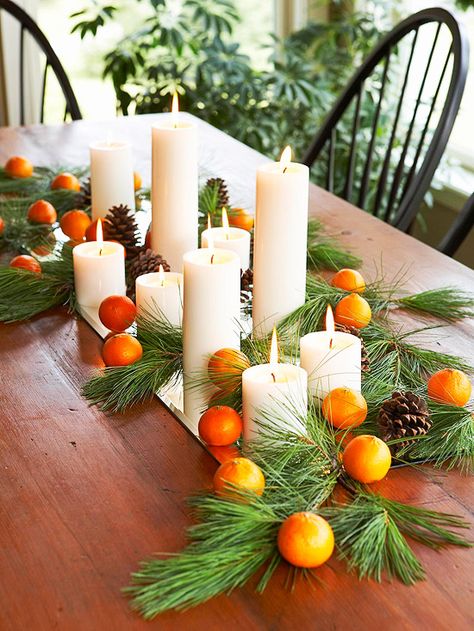 Another festive holiday table, this time decorated with candles, pine needles and clementines! More simple Christmas decorations: http://www.bhg.com/christmas/indoor-decorating/christmas-decorating-using-what-you-have/?socsrc=bhgpin110112clementinecenterpiece#page=14 Natal Natural, Natural Holiday Decor, Holiday Table Centerpieces, Deco Table Noel, Natural Christmas Decor, Christmas Tablescape, Holiday Day, Thanksgiving Centerpieces, Natural Christmas