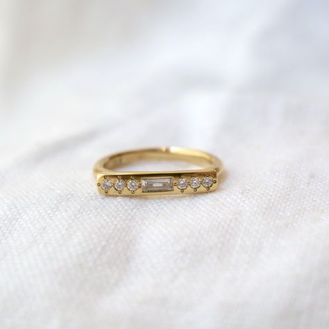 Our 14k gold Message style ring, set with a white Baguette Diamond at the center of four round white diamonds. Baguette Diamond: 4mmx2mm // GH color // SI1 clarity. Round Diamonds: 1.7mm Baguette Ring, Jewellery Ideas, Baguette Diamond, White Diamonds, Diamond White, Ring Set, Jewelry Care, Baguette, Round Diamonds