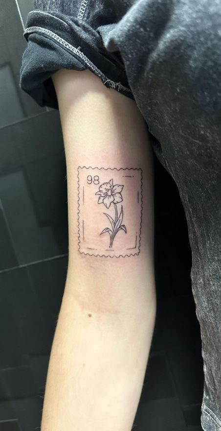 Stamp Tattoo Daffodil, Daffodil Postage Stamp Tattoo, Daffodil Tattoo Realistic, Daffodil Tattoo With Date, Daffodil Tattoo With Roman Numerals, Golden Rod Flower Tattoo, Easter Flower Tattoo, Daffodil Arm Wrap Tattoo, Unique Daffodil Tattoo