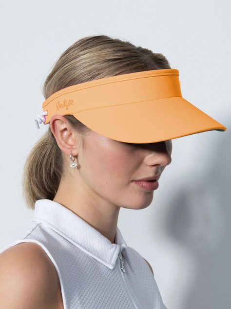 Model: Marina Visor Style: DS1000075.154, DS001-600, 343-600 Available Colors: White-100, Black-999, Navy-590, Birch-115, Dahlia-894, Pacific-566, Rose-800, Sandy-306 The Marina Visor functions as both a sun shade and an accessory to keep your hair out of your eyes. The shaded visor has an anti-glare green underside and a soft, sweat-wicking terry cloth interior. Adjust the size using the elasticated band at the back. Marina Visor is a golf visor with anti-glare green underside to counteract sun Golf Visor, Navy Accessories, Visor Hats, Modest Fashion Outfits, Cute Hats, Sun Shade, Terry Cloth, Dahlia, Modest Fashion