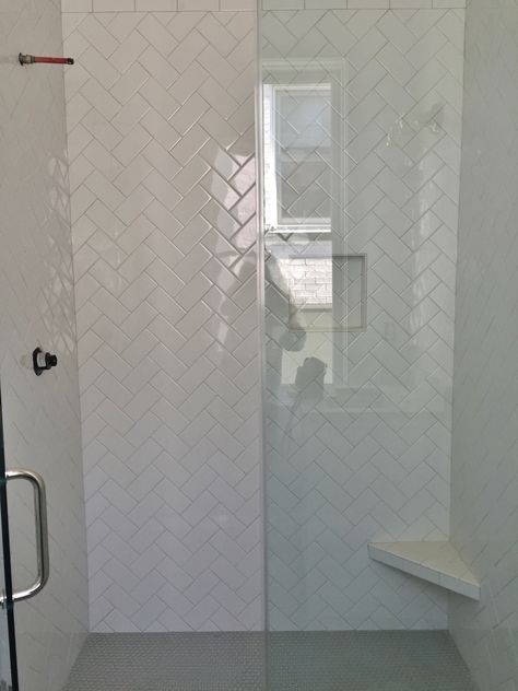 3x6 white subway tile set in herringbone pattern, gray penny rounds on floor. Subway Tile Herringbone, Herringbone Shower, Herringbone Subway Tile, White Subway Tile Shower, Penny Tile Floors, Bathroom Things, White Herringbone Tile, Herringbone Tile Floors, Patterned Bathroom Tiles