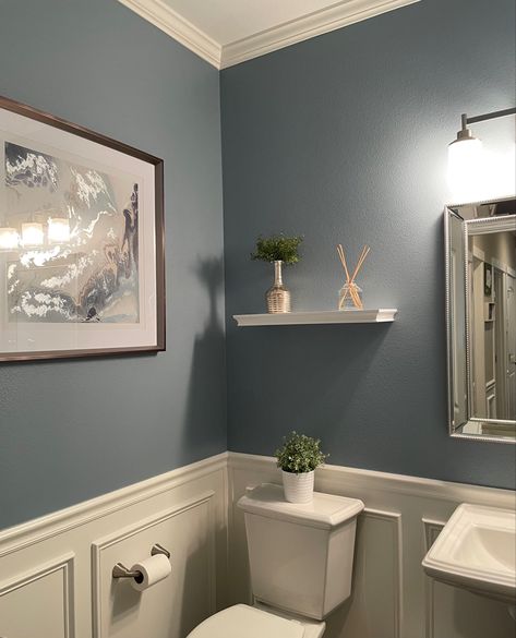 Blue bathroom with wainscoting and crown molding Bathroom Inspo Wall Color, Bathroom 2 Color Walls, Light Blue Wall Bathroom, Nice Bathroom Colors, Country Blue Bathroom Ideas, Blue Grey Paint Bathroom, Light Blue Walls With Accent Wall, Light Blue Restroom Ideas, Greyish Blue Bathroom