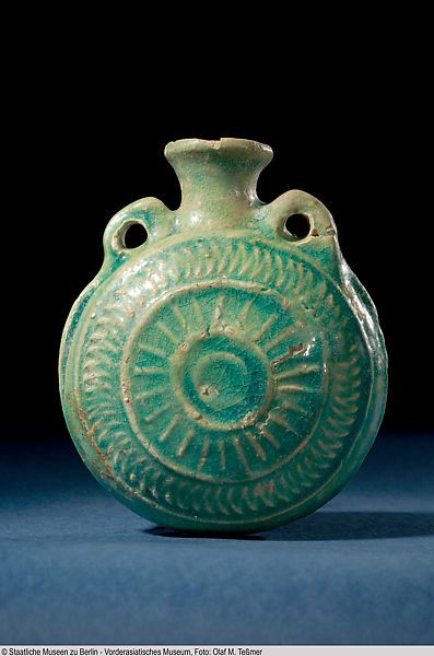 Pilgrim flask- Date:1st century B.C.–2nd century A.D. Geography:Mesopotamia, Ashur Medium:Glazed ceramic Dimensions:H. 5 7/16 × W. 4 1/2 × D. 2 5/16 in. (13.8 × 11.5 × 5.9 cm)| The Met Historical Ceramic Vessels, Historical Pottery Ceramics, Historic Ceramic Vessels, Ancient Vessels, Historical Pottery, Historical Ceramics, Ceramic Flask, Historic Ceramics, Red Moles